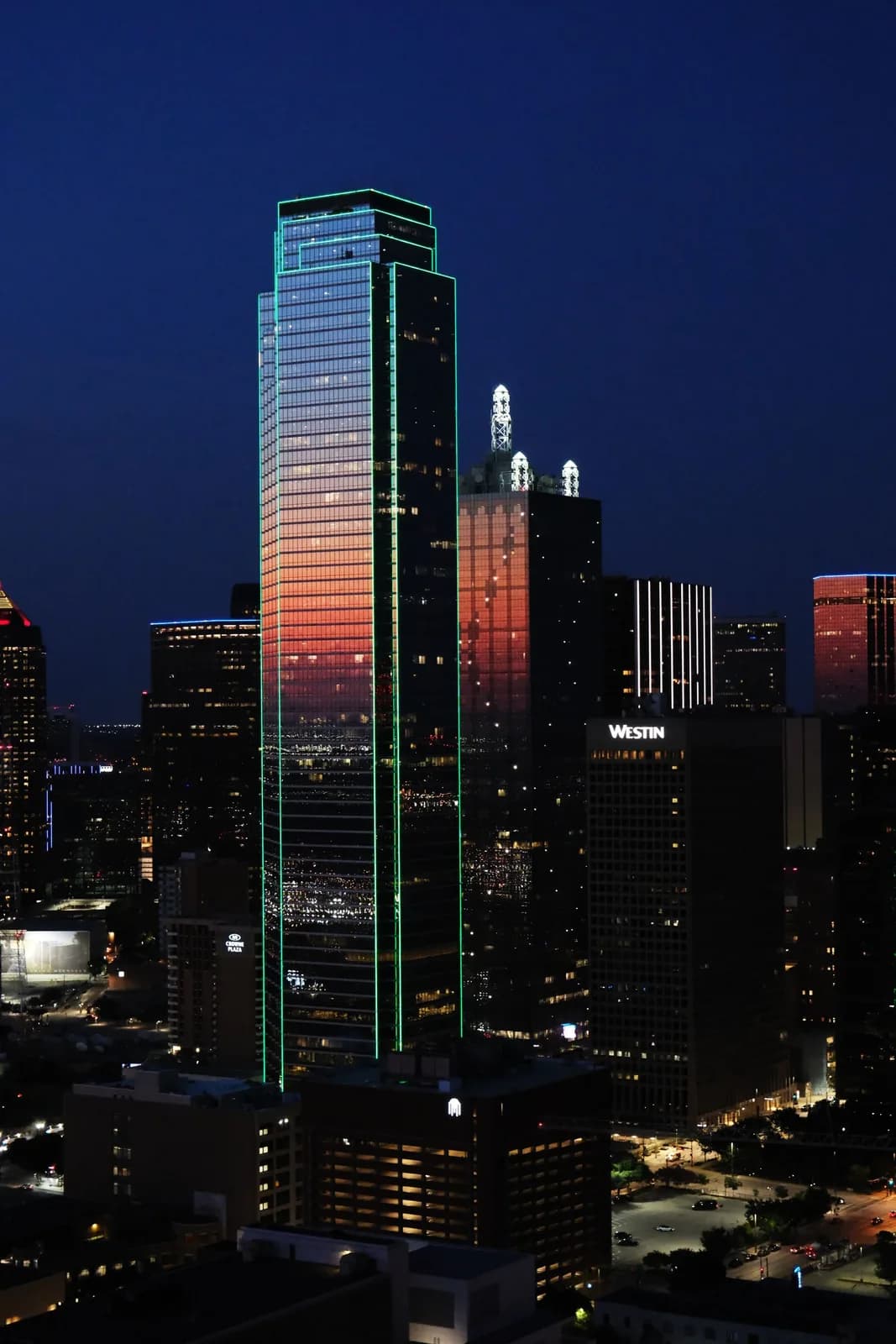 Illuminated buildings in downtown Dallas at sunset